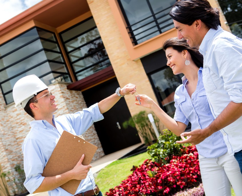 Architect handing keys to a couple